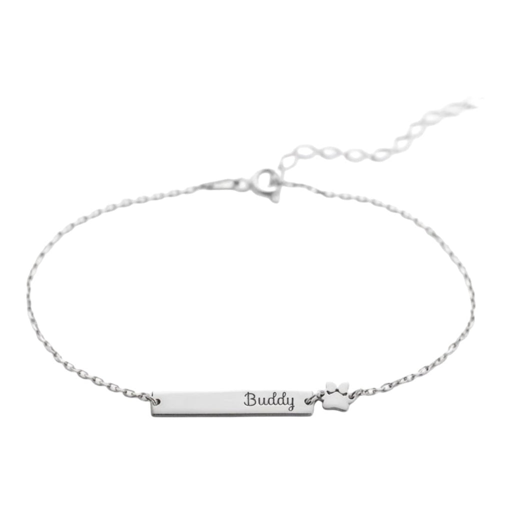 Bracelet fin en acier inoxydable avec plaque gravée "Buddy" et pendentif patte d'animal argenté.