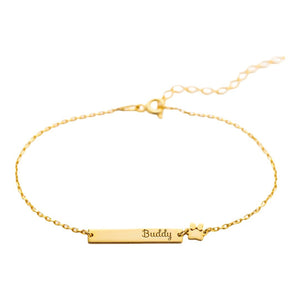 Bracelet fin doré avec plaque gravée "Buddy" et motif patte d'animal en acier inoxydable.