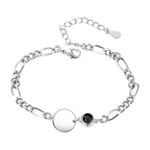 Bracelet argenté mailles figaro avec pendentif rond lisse et petit médaillon noir éclatant.