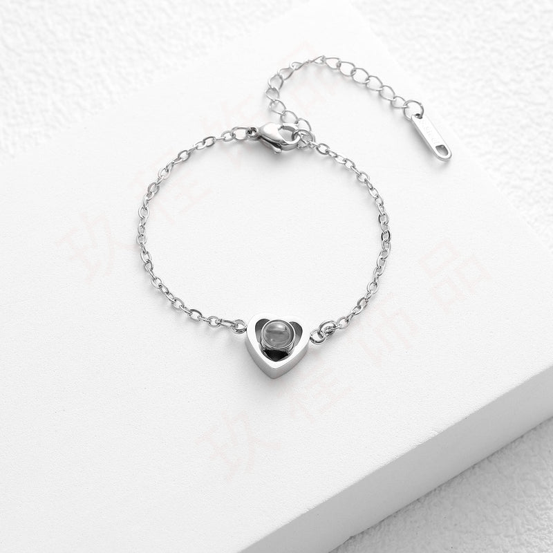 Bracelet en acier inoxydable argenté avec pendentif cœur personnalisable et chaîne fine ajustable.