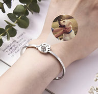 Bracelet en titane argenté avec patte d'animal et photo ronde personnalisée.