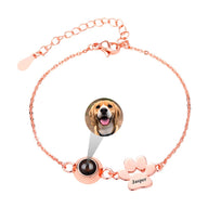 Bracelet en acier inoxydable or rosé avec médaille photo ronde et breloque patte à graver personnalisée.