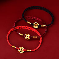 Bracelets porte-bonheur en nylon tressé rouge, bordeaux et noir avec charms dorés et perles fines.