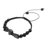 Bracelet noir en pierres naturelles polies avec éclats bruts et cordon réglable tressé.