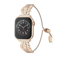 Bracelet or rosé pour Apple Watch avec ailes d'ange scintillantes en acier inoxydable, fermeture chaîne ajustable.