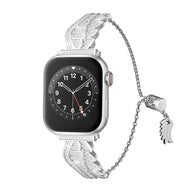 Bracelet argenté en acier inoxydable avec design ailes d’ange scintillantes pour Apple Watch.