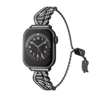 Bracelet pour Apple Watch noir en acier inoxydable avec ailes d'ange scintillantes et fermoir réglable.