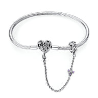 Bracelet chaîne en argent avec fermoir cœur orné de motifs élégants et chaîne de sécurité fine.