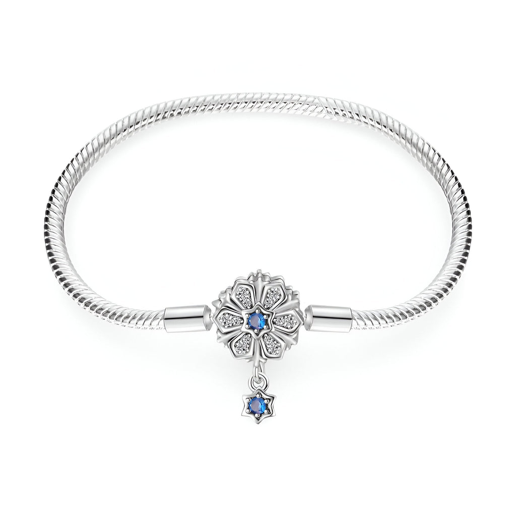 Bracelet argent serpent avec charm fleur et pendentif étoile bleue élégante.