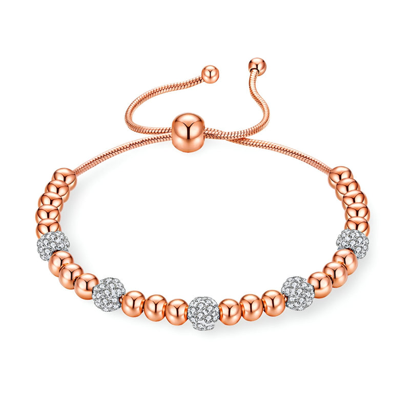 Bracelet pour femme en titane or rosé avec perles lisses et zircones synthétiques étincelantes.