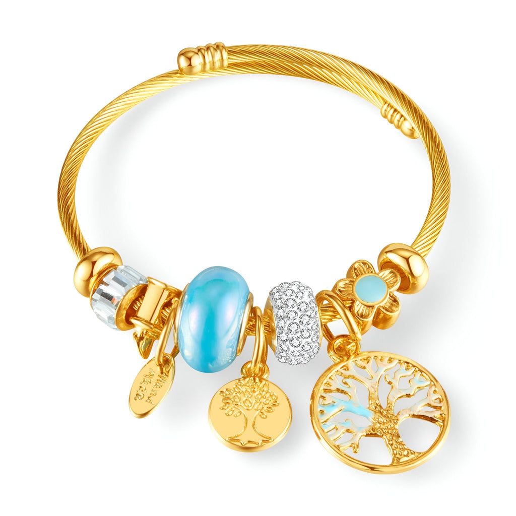 Bracelet or en acier inoxydable avec charms turquoise et arbre de vie ajouré doré.