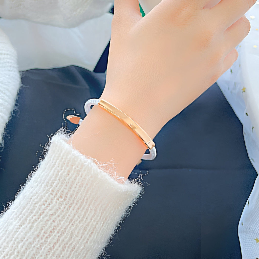 Bracelet pour femme en cordon bleu avec plaque dorée fine et élégante.
