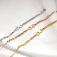 Trois bracelets femme en acier inoxydable perlé avec motif infini en argent, cuivre et or rose.