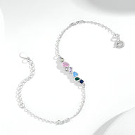 Bracelet femme en argent sterling avec pendentifs colorés en zircon de formes géométriques.