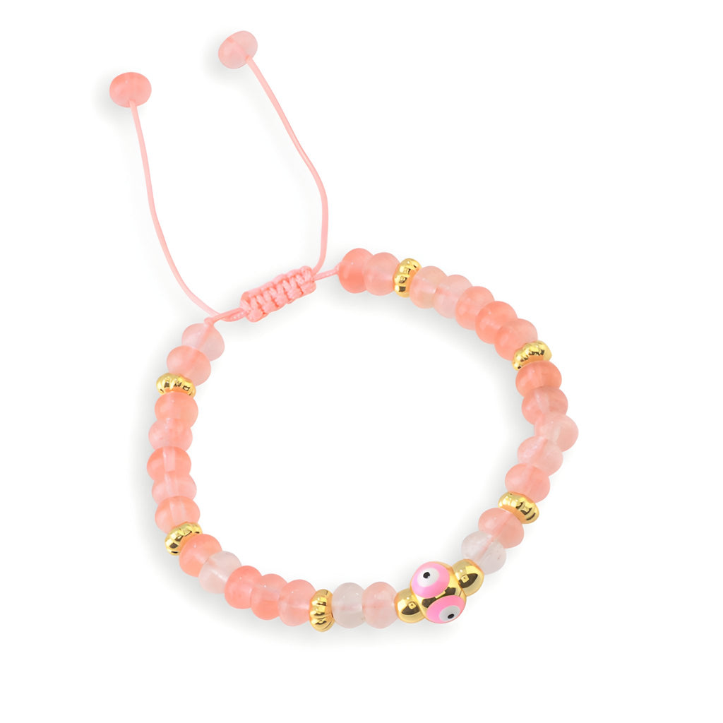 Bracelet femme en perles de quartz rose, petit œil rose et détails dorés, cordon réglable.