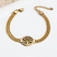 Bracelet femme en titane or avec pendentif arbre de vie serti de pierres blanches.