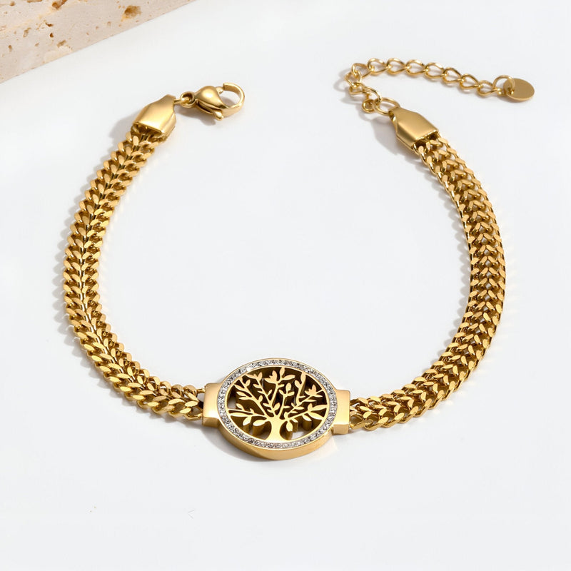 Bracelet femme en titane or avec pendentif arbre de vie serti de pierres blanches.