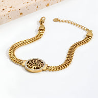 Bracelet femme en titane or avec pendentif arbre de vie rond et chaîne maille tressée.