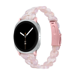 Bracelet Samsung Watch en résine rose pâle, maille épaisse chic, boucle déployante rose métallique.