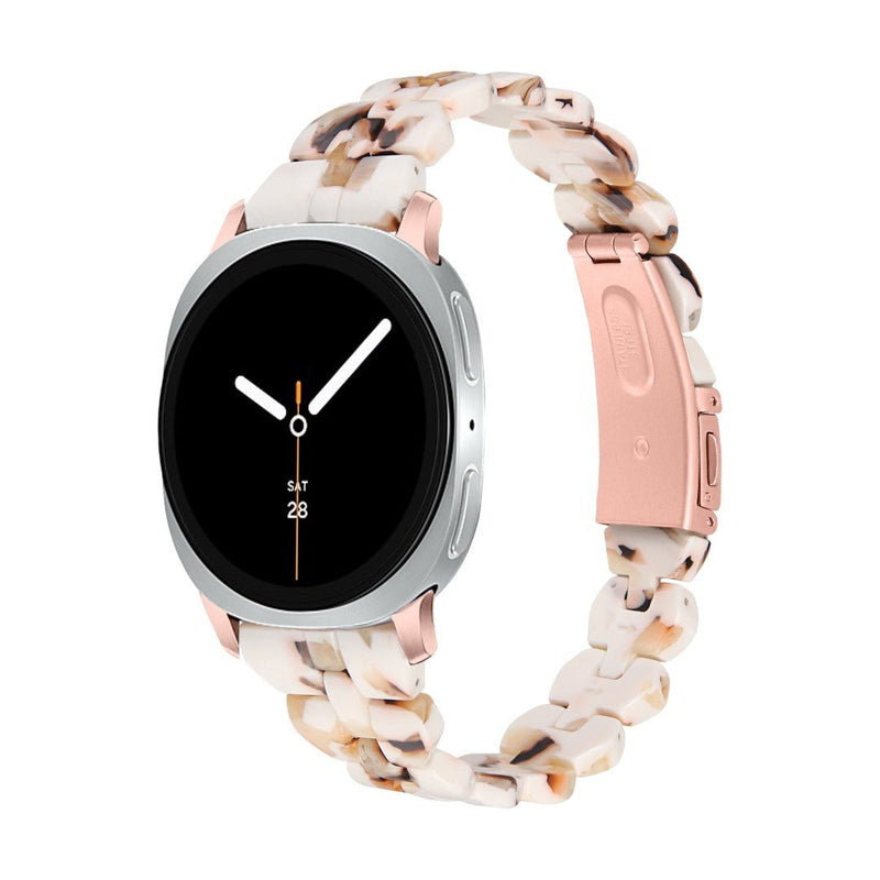 Bracelet montre Samsung en résine marbrée beige rose avec maille épaisse et boucle déployante acier rose pâle.