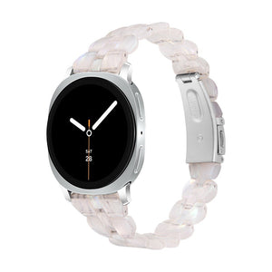 Bracelet Samsung Watch en résine rose translucide à maillons épais avec boucle déployante en acier argenté.