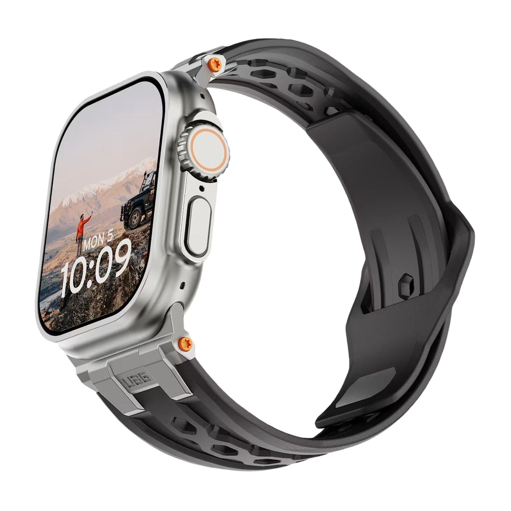 Bracelet silicone noir robuste pour Apple Watch avec design perforé et fermoir métal gris anthracite.