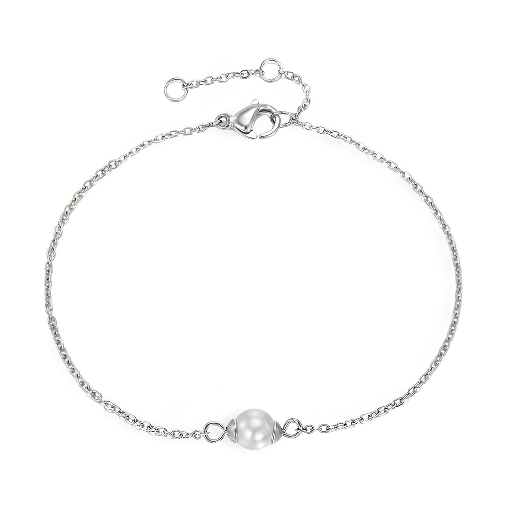 Bracelet fin en acier inoxydable argenté avec perle centrale blanche lisse.