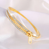 Bracelet femme en titane doré, design fermeture éclair avec détails argentés brillants.