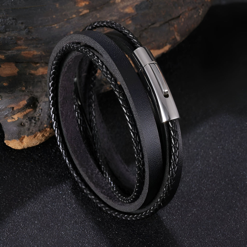 Bracelet tressé en cuir noir multi tours avec fermoir métallique argenté brillant.