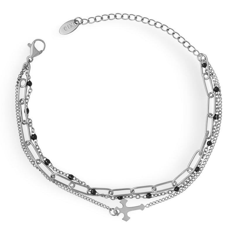 Bracelet triple mailles en titane plaqué or avec motif croix délicat et chaînette ajustable.