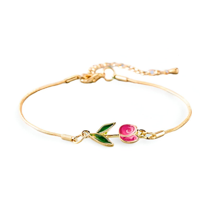 Bracelet en cuivre doré avec pendentif tulipe rose et feuille verte délicate.