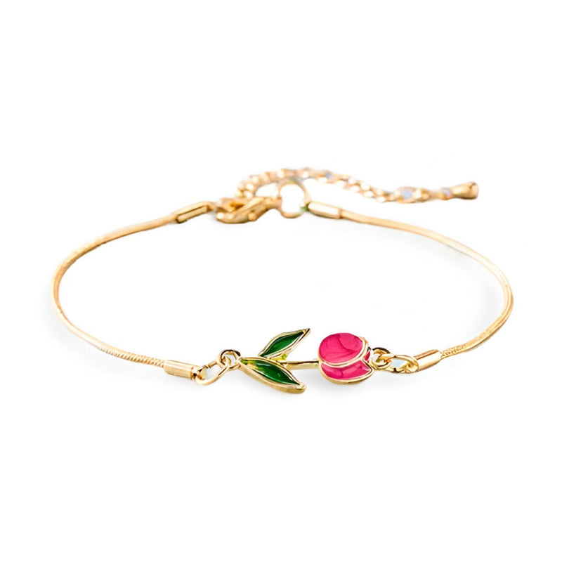 Bracelet fin en cuivre doré avec pendentif tulipe rose et feuilles vertes émaillées.
