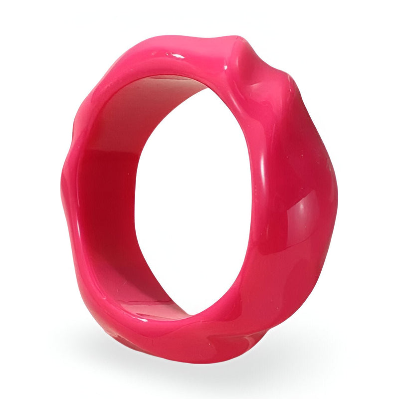 Bracelet en acrylique rose vif avec surface ondulée et finition brillante.