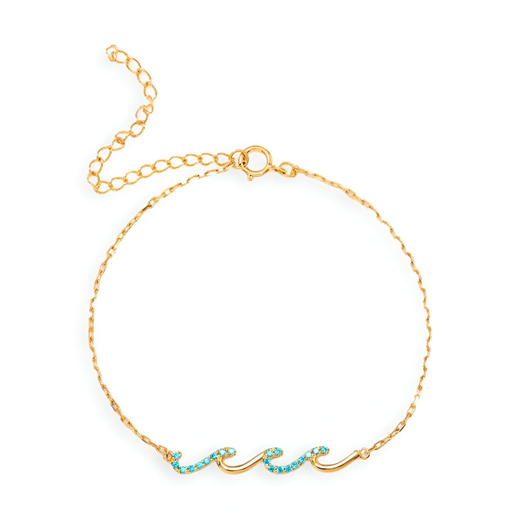 Bracelet en argent doré avec motif de vagues ornées de pierres turquoise sur chaîne fine.