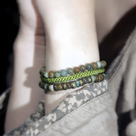 Trio de bracelets femme en pierre naturelle bleu-vert et cordon vert tressé sur poignet.