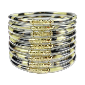 Neuf bracelets joncs empilables en silicone souple noir et doré avec détails dorure brillante et design minimaliste.