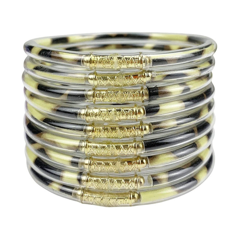 Neuf bracelets joncs empilables en silicone souple noir et doré avec détails dorure brillante et design minimaliste.