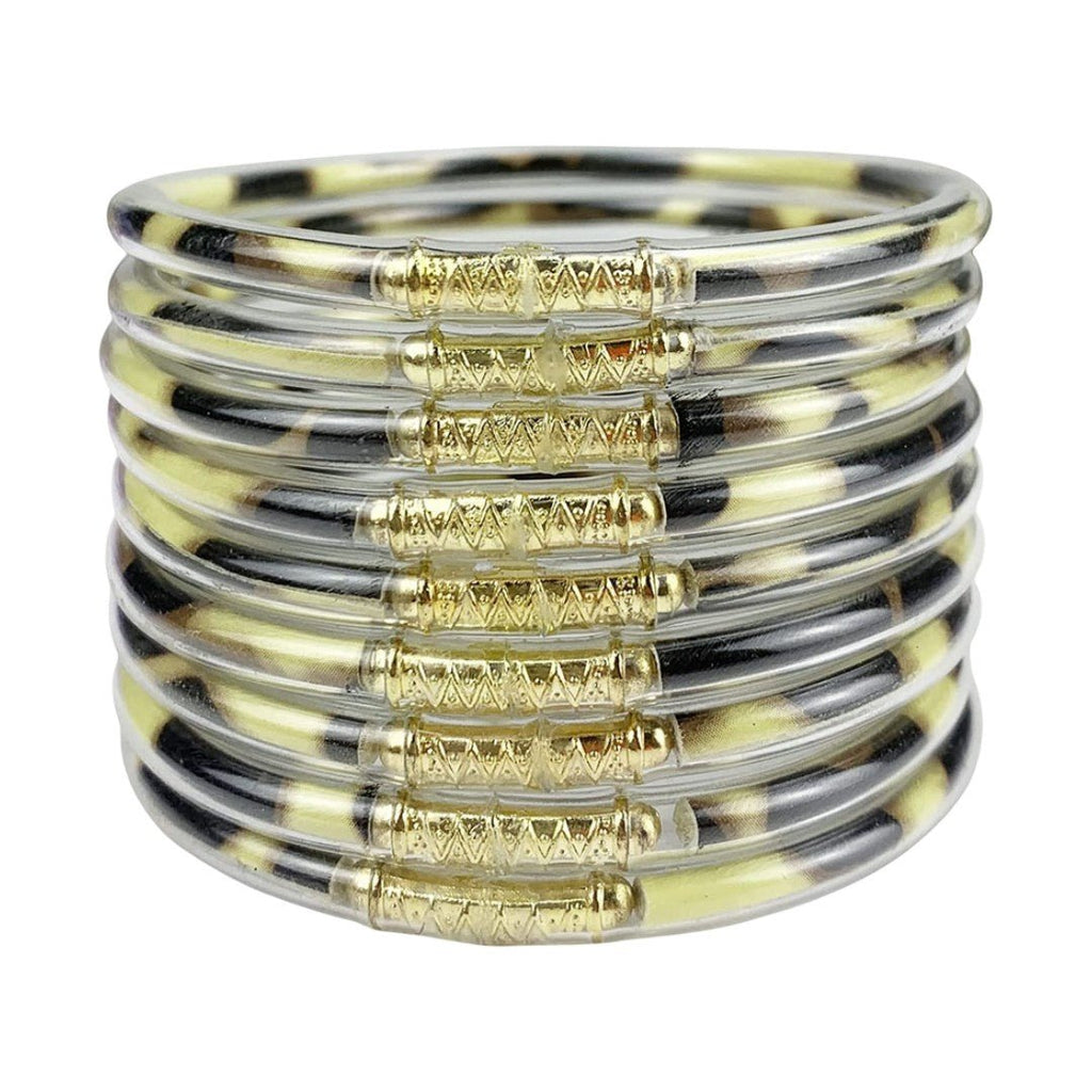 Neuf bracelets joncs empilables en silicone souple noir et doré avec détails dorure brillante et design minimaliste.