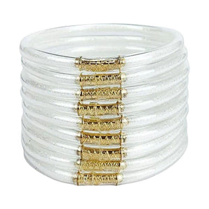 Lot de 9 bracelets joncs empilables en silicone transparent souple avec détails dorés brillants, design minimaliste.