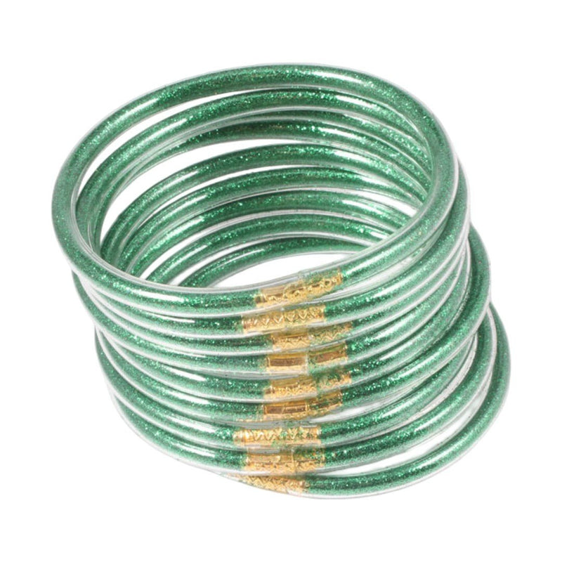 Bracelets joncs vert émeraude en silicone souple avec dorure brillante, design empilable et minimaliste.