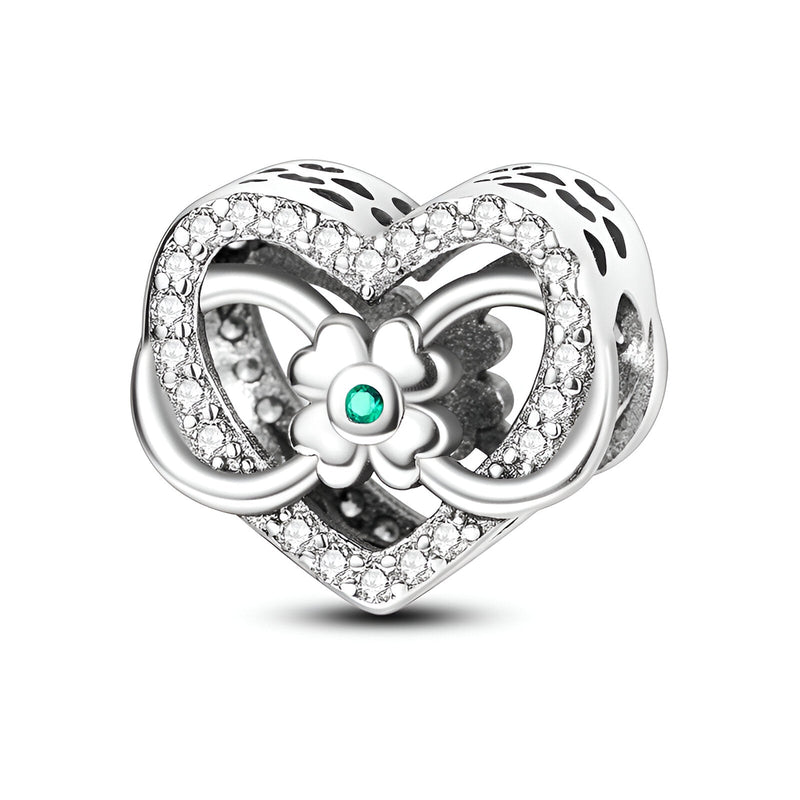 Charm cœur en argent avec trèfle et symbole infini, serti de pierres blanches et détail turquoise au centre du trèfle.