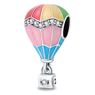 Charm montgolfière en argent avec émaillage multicolore rose, rouge, jaune, vert et bleu, détails en cristaux blancs.