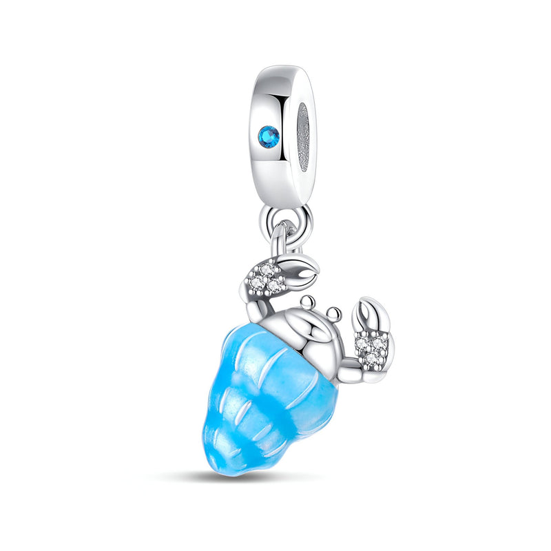 Pendentif charm crabe argenté avec coquillage bleu translucide et pierre bleue sur anneau.