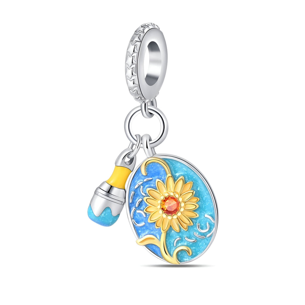 Pendentif charm en émail bleu avec tournesol jaune et breloque goutte bleue sur anneau strassé argenté.