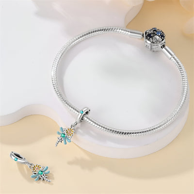 Bracelet argenté avec pendentif libellule turquoise sur marguerite blanche et breloque assortie.