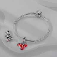 Bracelet argenté avec charm pendant Cancer rouge et argent orné de petits cristaux.