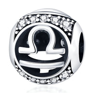 Charm rond en argent avec symbole zodiaque Balance noir et strass scintillants.