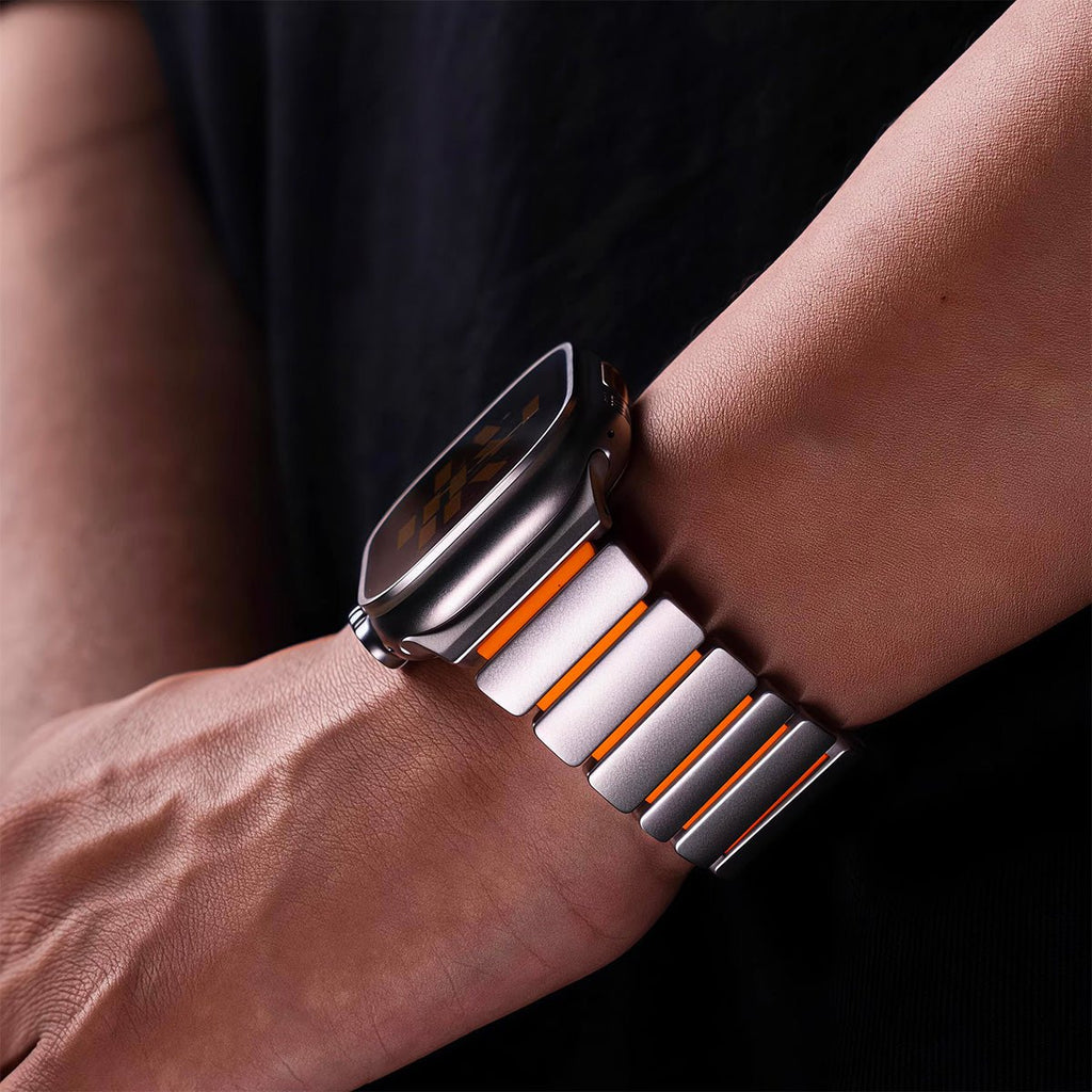 Coque intégrale en titane gris mat avec bracelet silicone blanc et orange pour Apple Watch, design robuste et élégant.