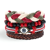 Ensemble de 4 bracelets tressés rouge, blanc, noir avec perles et œil de protection central en métal, cuir marron foncé.