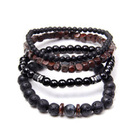 Ensemble de quatre bracelets noirs en bois, pierres volcaniques et perles lisses, pour homme.